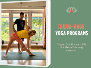 Yoga teacher assisting a student in triangle pose at Akshara Yoga School, rural India — personalized tailor-made yoga program.