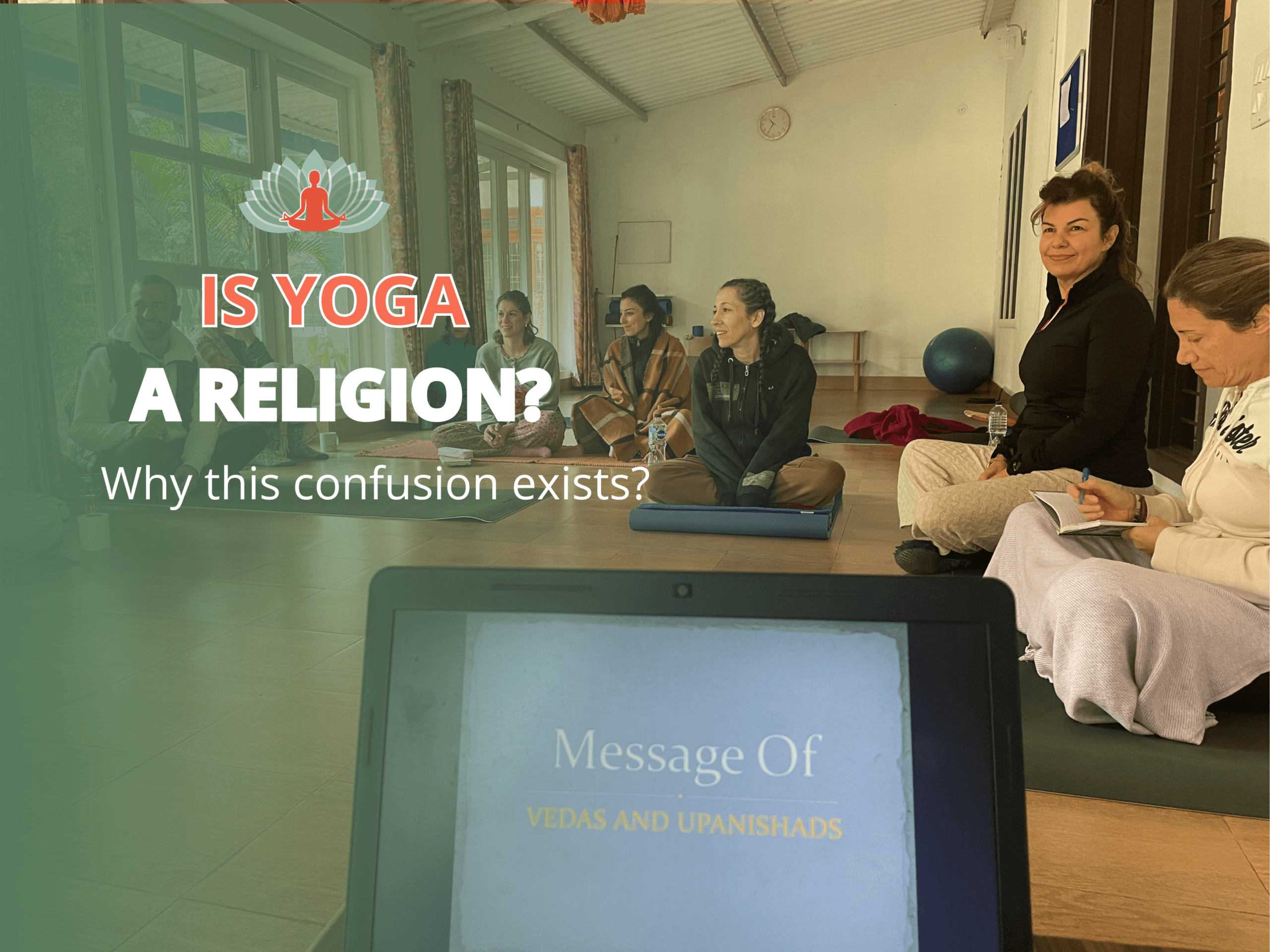 Students sitting in a yoga philosophy class at Akshara Yoga School in rural India, discussing the Vedas and Upanishads during a teacher training course.